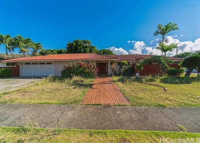 single story home with a garage and a front lawn