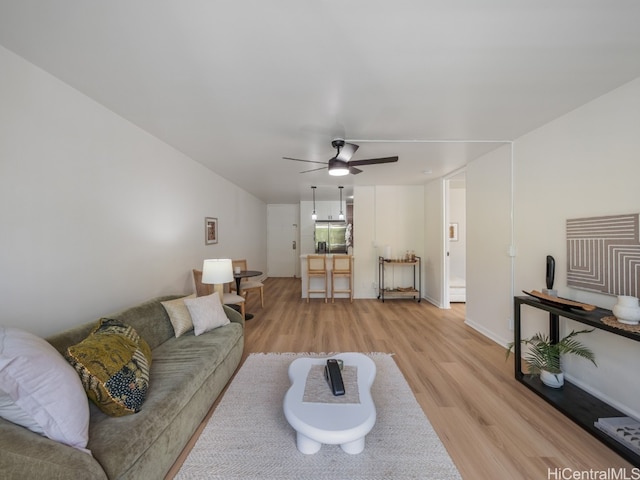 living room featuring ceiling fan and light wood-type flooring