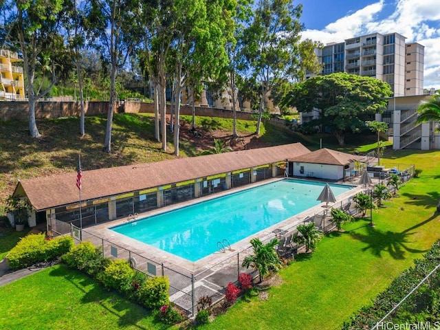 view of pool with a yard