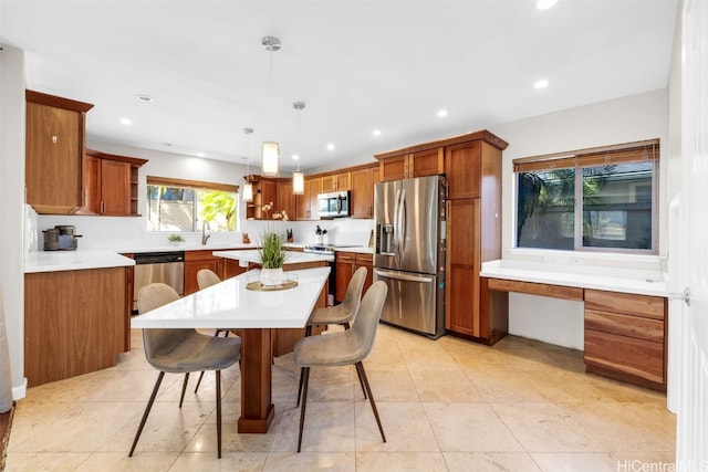 kitchen featuring a kitchen island, a breakfast bar area, stainless steel appliances, light tile patterned flooring, and decorative light fixtures