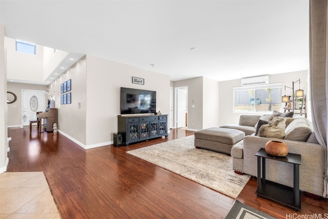 living room featuring an AC wall unit, hardwood / wood-style floors, and a skylight