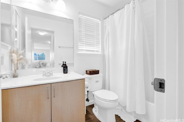 full bathroom featuring vanity, toilet, hardwood / wood-style flooring, and shower / bath combination with curtain