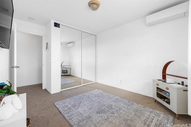 bedroom with a closet, an AC wall unit, and carpet flooring