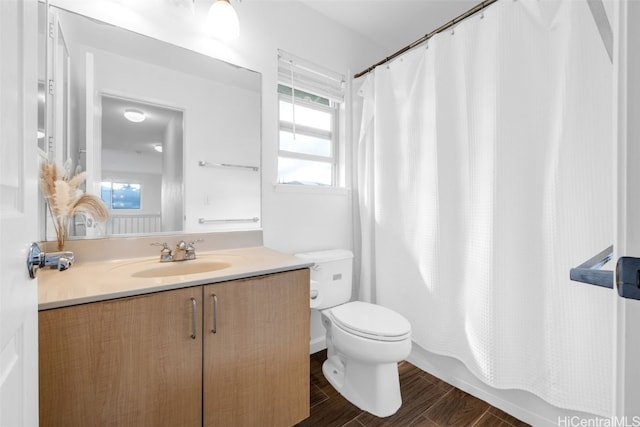 full bathroom featuring vanity, shower / bath combination with curtain, hardwood / wood-style flooring, and toilet