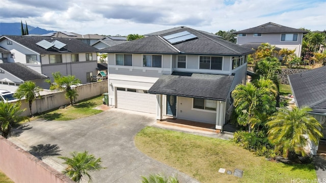 view of front of home with a front yard and a garage