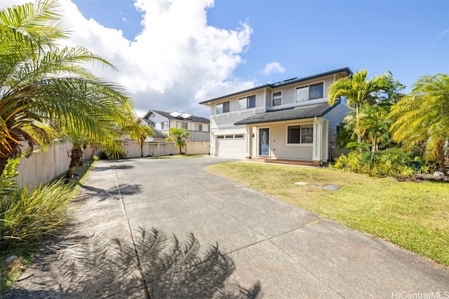 view of front of home with a front yard and a garage