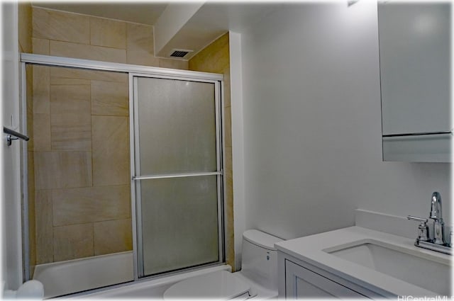 full bathroom featuring shower / bath combination with glass door, vanity, and toilet