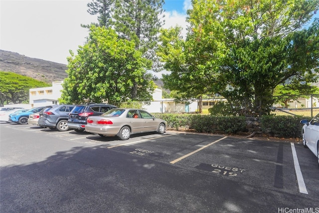 view of vehicle parking featuring a mountain view