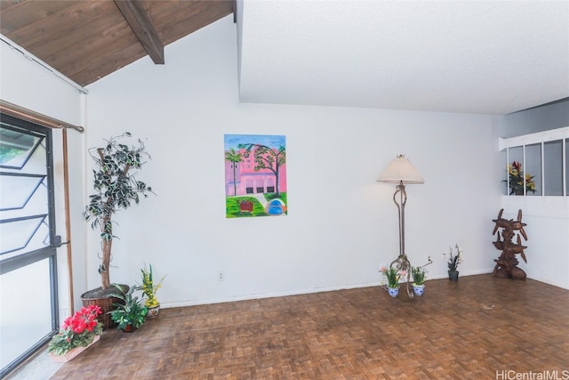 interior space featuring lofted ceiling with beams and parquet flooring