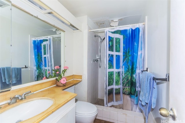 bathroom with vanity, curtained shower, and toilet