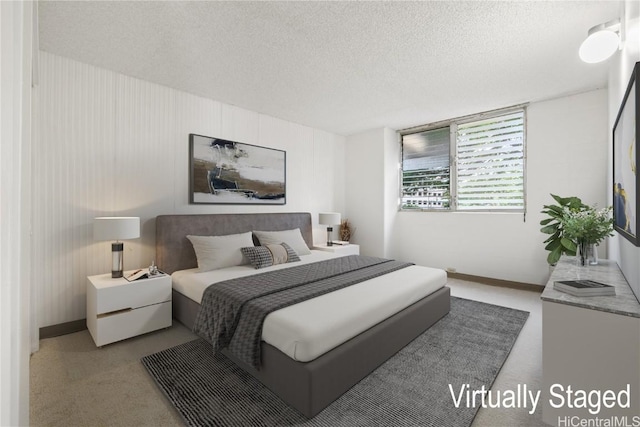 carpeted bedroom featuring a textured ceiling