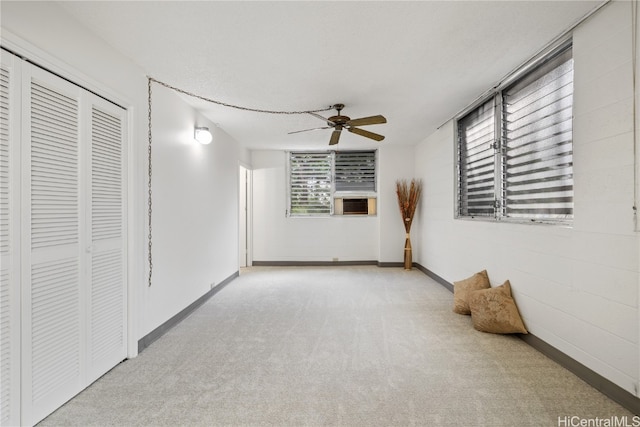 unfurnished room with carpet flooring, baseboards, and ceiling fan