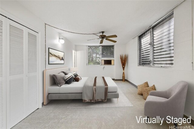 bedroom with a closet, carpet flooring, and a ceiling fan