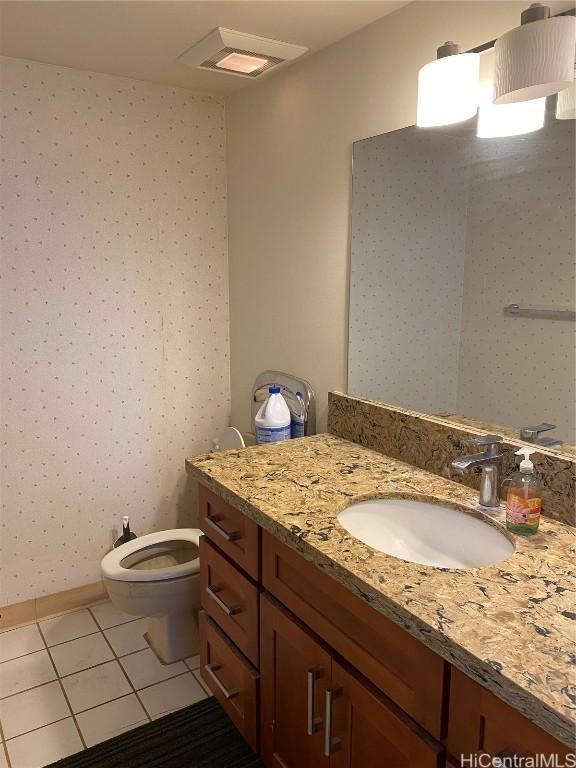 bathroom with tile patterned flooring, vanity, and toilet