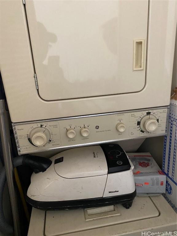 laundry area with stacked washer / drying machine