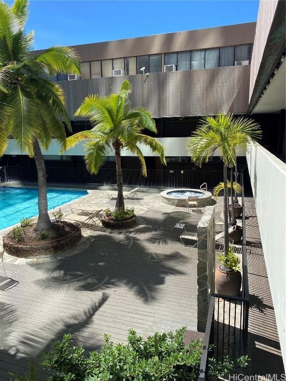 view of pool featuring a community hot tub and a patio