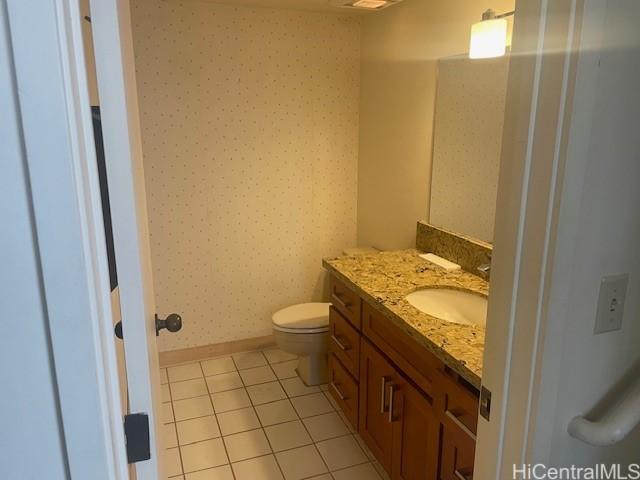1088 Bishop St Unit 1213, Honolulu, HI 96813 - bathroom featuring wallpapered walls, vanity, tile patterned flooring, toilet, and baseboards