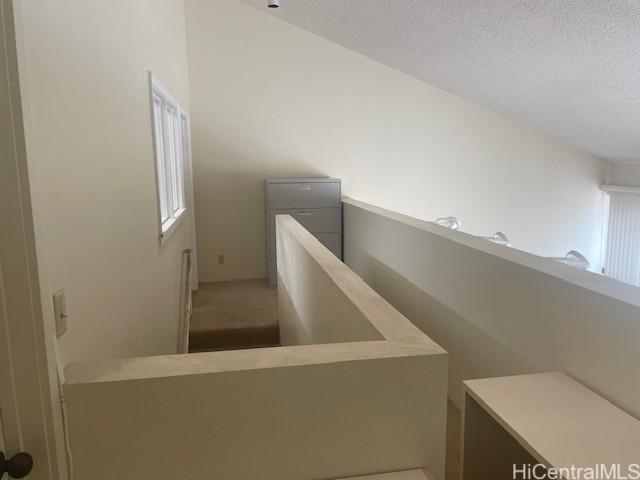 1088 Bishop St Unit 1213, Honolulu, HI 96813 - stairs featuring a textured ceiling and carpet floors