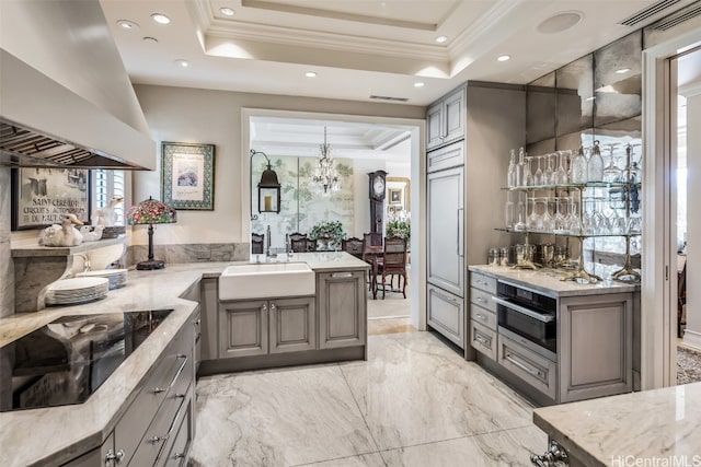 kitchen featuring sink, stainless steel oven, black electric cooktop, custom exhaust hood, and gray cabinets