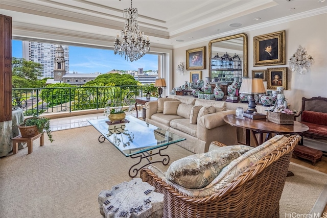 living room featuring an inviting chandelier, ornamental molding, and a raised ceiling