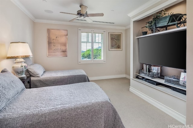 carpeted bedroom with ornamental molding and ceiling fan