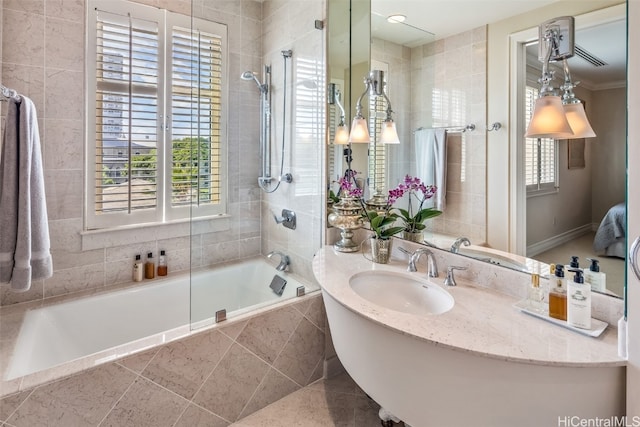 bathroom with crown molding, tiled shower / bath combo, sink, and tile patterned floors