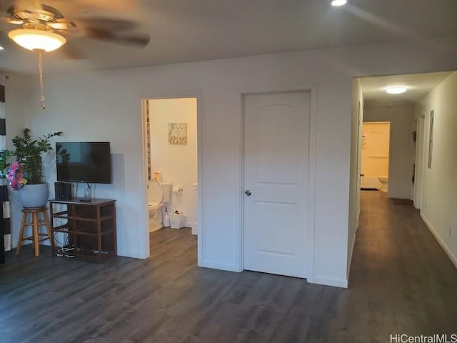 interior space with dark hardwood / wood-style floors and ensuite bathroom