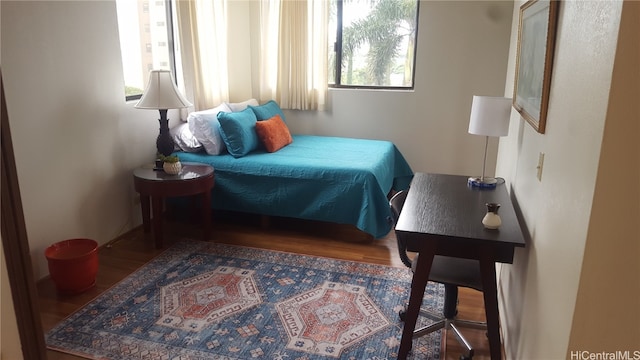 bedroom with dark wood-type flooring