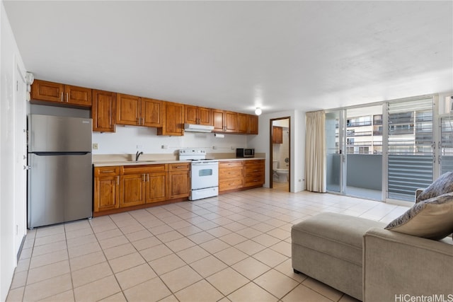 kitchen featuring sink, appliances with stainless steel finishes, and light tile patterned floors