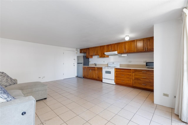 824 Kinau St Unit 712, Honolulu, HI 96813 - kitchen featuring white electric range oven, light countertops, freestanding refrigerator, stainless steel microwave, and under cabinet range hood