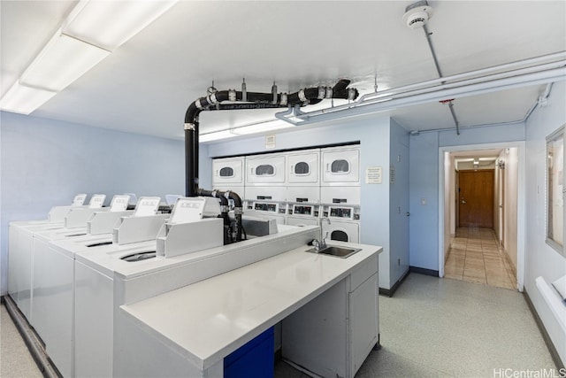 laundry area with stacked washer / drying machine and washer and clothes dryer