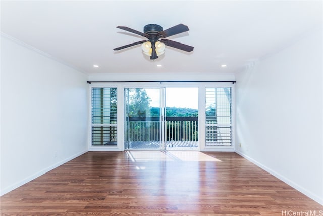 empty room with ceiling fan, wood-type flooring, and ornamental molding