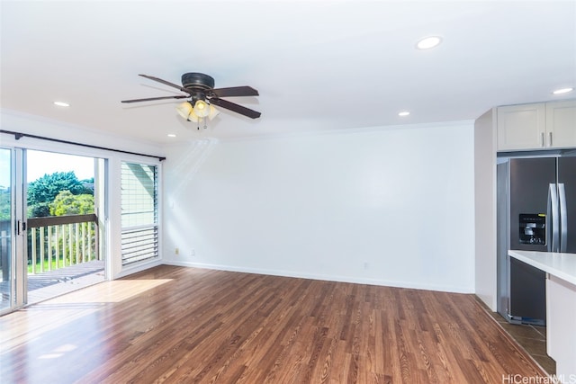 unfurnished living room with ceiling fan, ornamental molding, and dark hardwood / wood-style floors