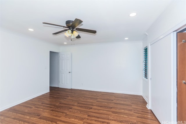 spare room featuring crown molding, ceiling fan, and dark hardwood / wood-style flooring