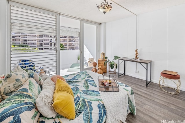 bedroom with a textured ceiling and hardwood / wood-style floors