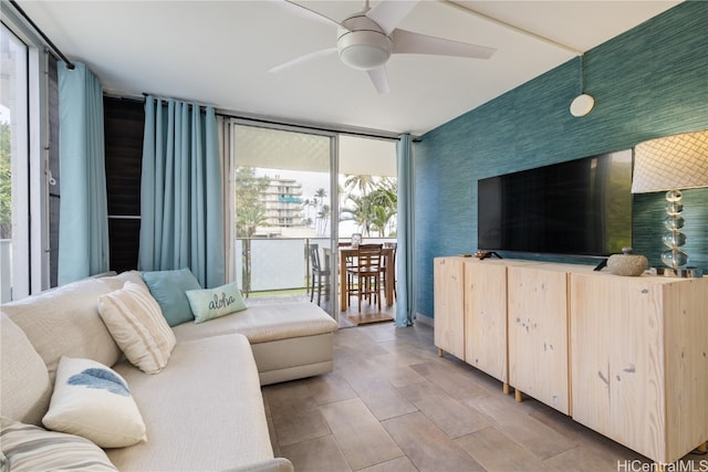 living room featuring floor to ceiling windows, plenty of natural light, and ceiling fan