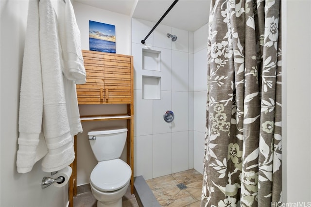 bathroom featuring toilet and walk in shower