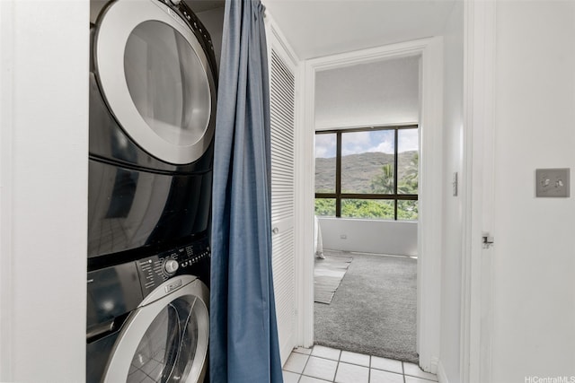 6770 Hawaii Kai Dr Unit 302, Honolulu, HI 96825 - laundry area featuring light carpet, stacked washer / dryer, light tile patterned floors, and a mountain view