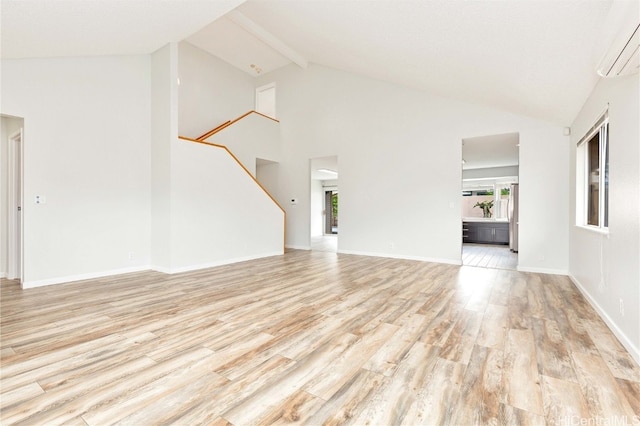 unfurnished living room with an AC wall unit, beamed ceiling, high vaulted ceiling, and light wood-type flooring