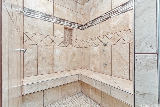 interior details with a tile shower