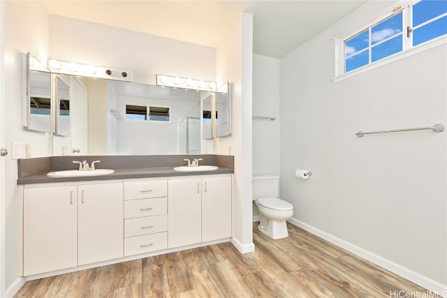 bathroom with vanity, hardwood / wood-style floors, and toilet