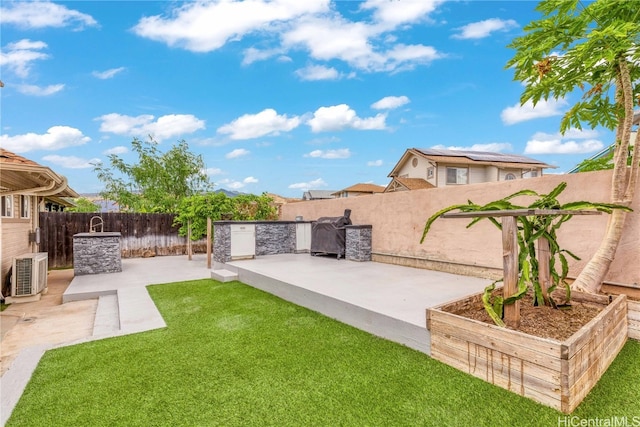 view of yard with a patio area and central AC unit