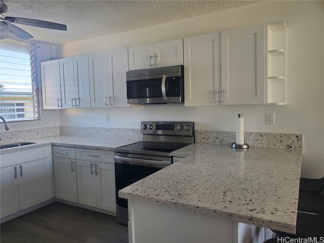 kitchen featuring stainless steel appliances, sink, dark hardwood / wood-style flooring, and white cabinets