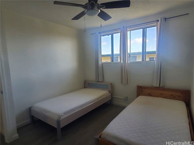 bedroom with dark wood-type flooring and ceiling fan