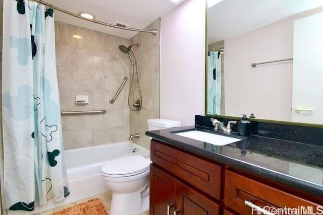 full bathroom featuring vanity, shower / bath combination with curtain, and toilet