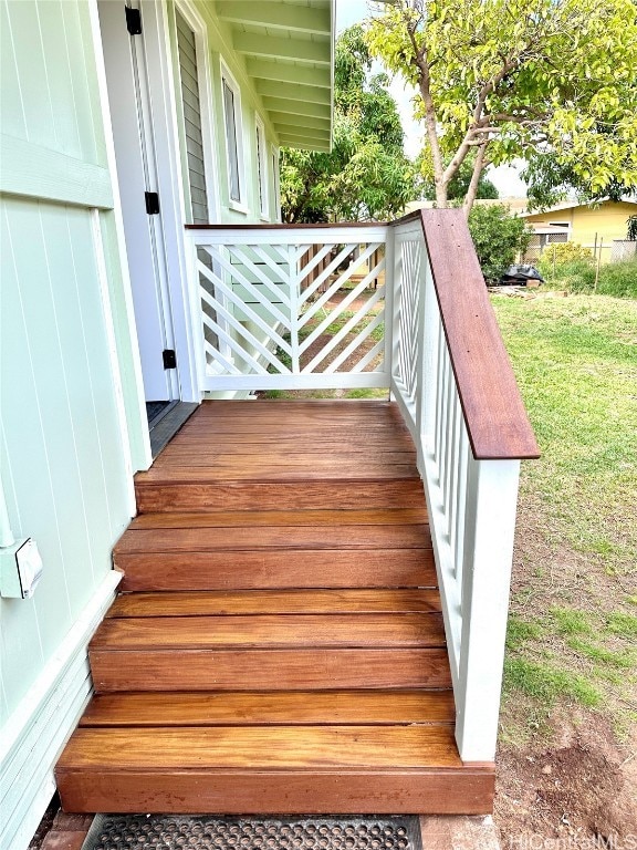 wooden terrace featuring a yard