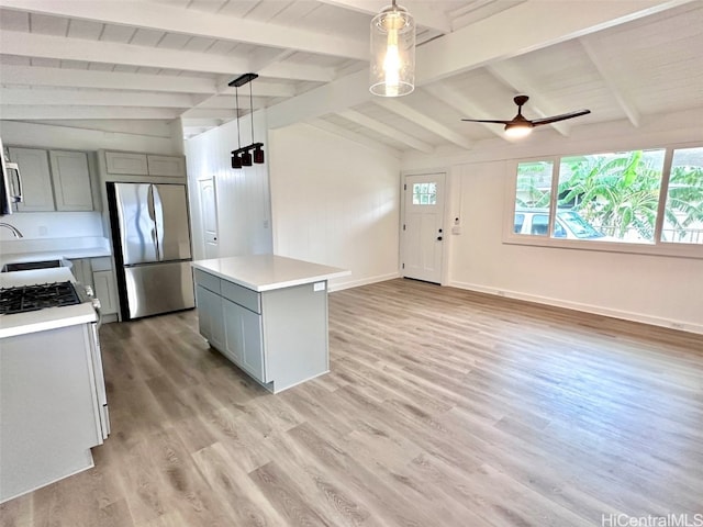 kitchen featuring stainless steel fridge, hanging light fixtures, vaulted ceiling with beams, light hardwood / wood-style flooring, and gray cabinetry