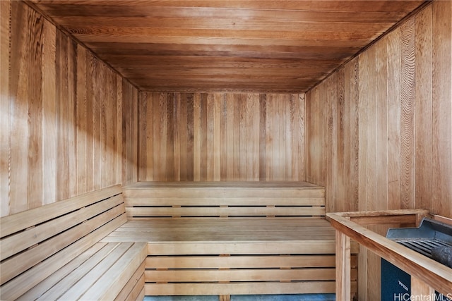 view of sauna / steam room featuring wood ceiling and wood walls