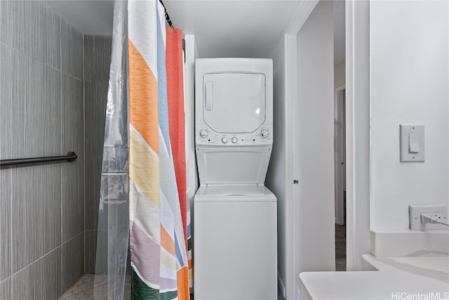 washroom featuring stacked washer / drying machine