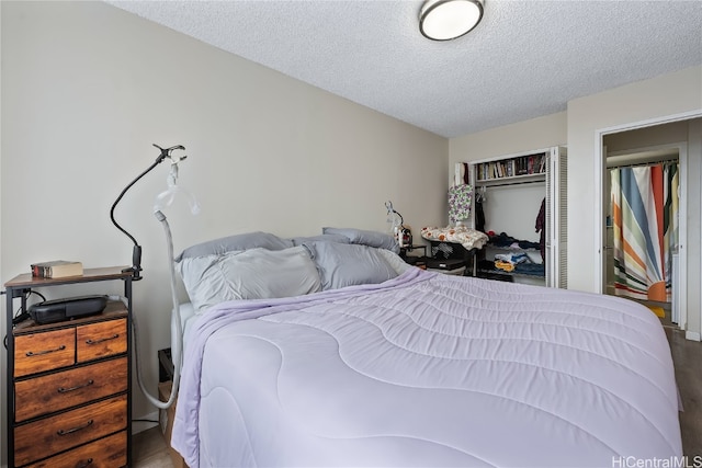 bedroom with hardwood / wood-style floors and a textured ceiling